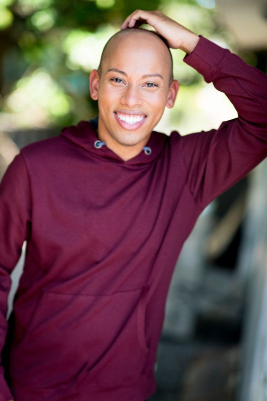 Lemar in a maroon hoodie under trees