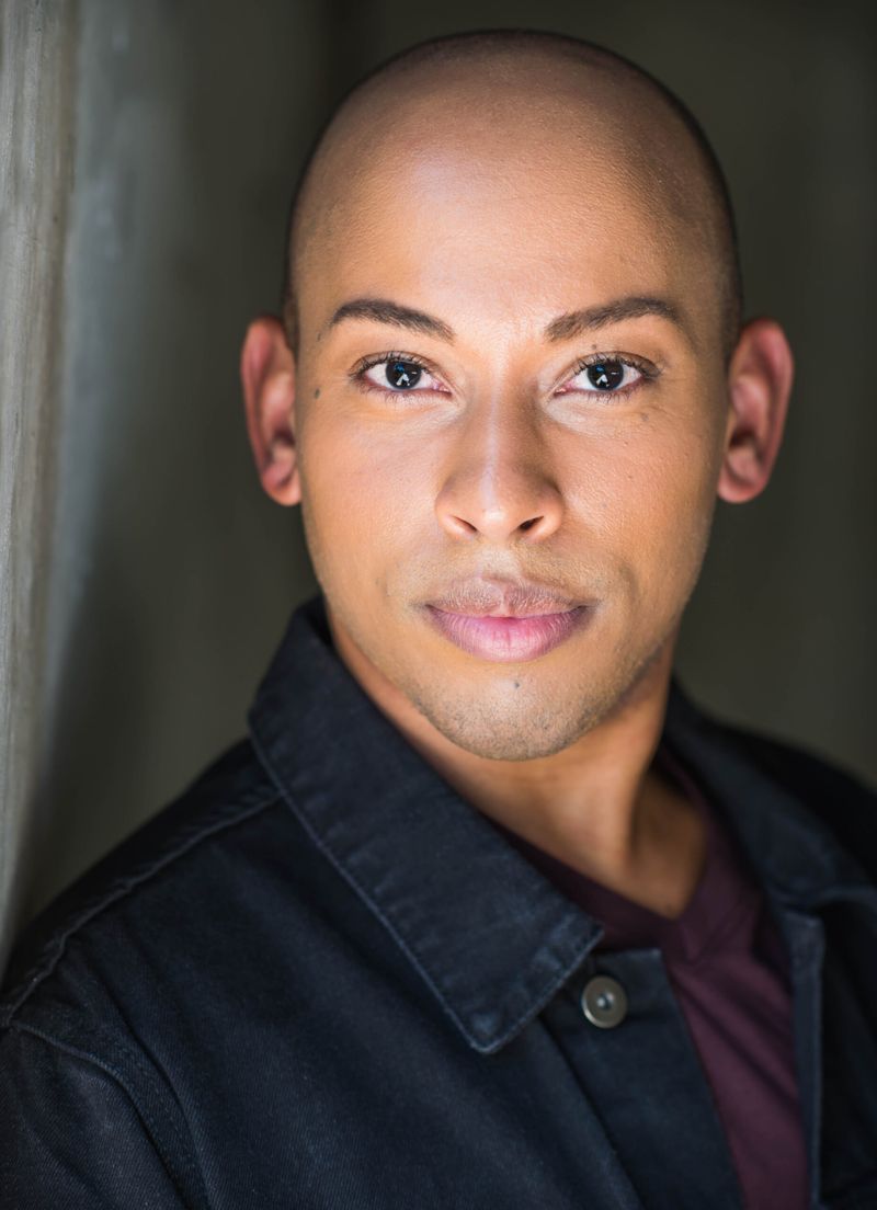 Lemar Scott headshot in a dark jacket